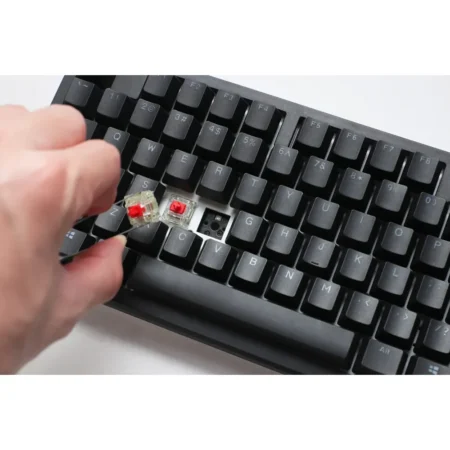 A detailed macro shot with a keycap removed, revealing the hyper-fast Cherry MX2A Speed Silver switch and the hot-swappable flex-cut PCB.