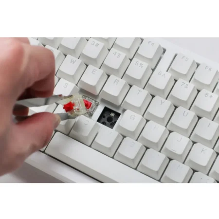 A detailed macro shot with a keycap removed, revealing the hyper-fast Cherry MX2A Speed Silver switch and the hot-swappable flex-cut PCB.